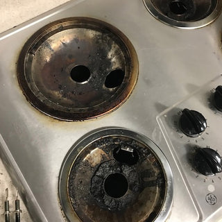 photo of dirty drip bowls on stove
