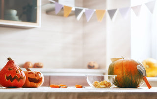 Carved pumpkins on a kitchen counter