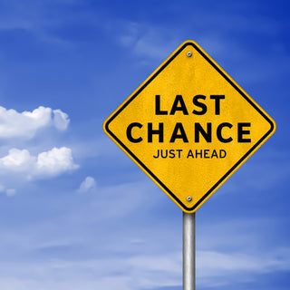 Last Chance Ahead road sign on blue sky and cloud background