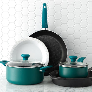cookware, stoneware and cast iron pieces stacked up