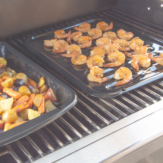 Shrimp and vegetables on oem-quality porcelain air fry, bake and broiler pan over a barbecue grill.