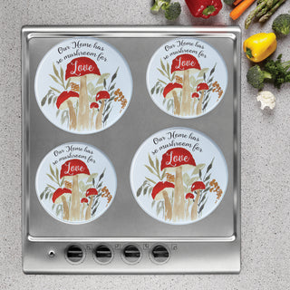 Mushroom Love burner covers on stainless steel stove with gray speckled counter