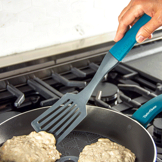 gif of taste of home slotted spatula making  turning pancakes on a gas stove in a taste of home skillet