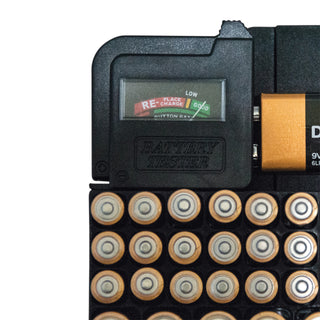 Close up of Battery tester  testing a 9 volt battery with digital display and multiple batteries on a white background