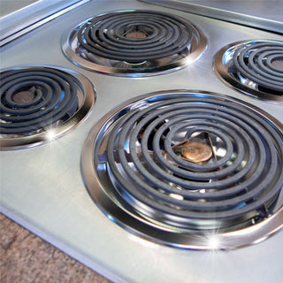 after photo of clean electric coil stove with new drip bowls installed