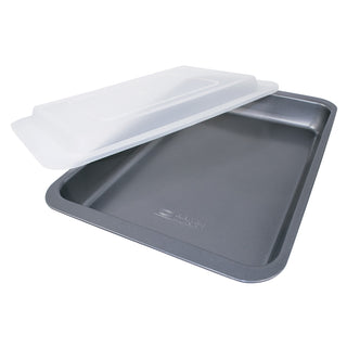 Gray baking tray with a plastic travel  lid on a white background