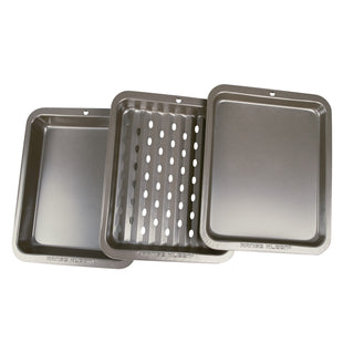 Set of three metal toaster oven baking pieces on a white background
