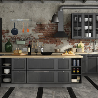 stainless steel expanding pot rack hanging from brick wall in gray toned kitchen