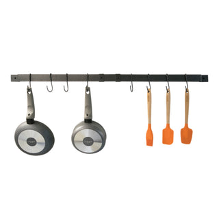 hammered gray expanding pot rack at full expansion with kitchen tools and cookware hanging