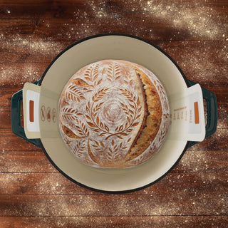 baked bread in a hot cast iron dutch oven using the round silicone bread sling