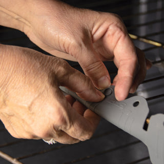 Attaching oven rack edge guard in the oven.