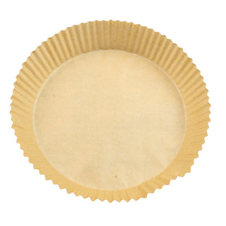 overhead view of round parchment air fryer liner on white background