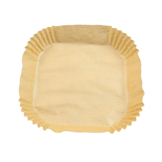 overhead view of parchment air fryer liner on white background