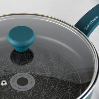 Feature upclose view of Taste of Home 4 quart saute pan with tempered glass lid on white background