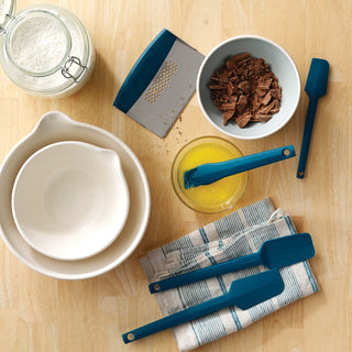 Taste of home silicone tools and baking ingredients on a wooden surface