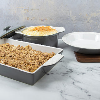 2 quart casserole with lid with mashed potatoes inside, crumbly apple dessert in 13 x 9-inch stoneware baking dish and pie plate on marble counter. 
