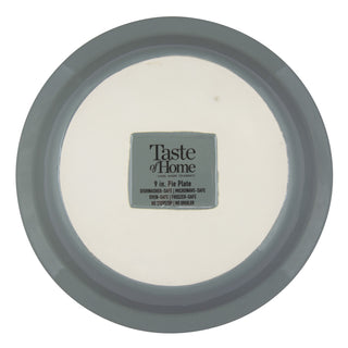 Round stoneware pie plate with 'Taste of Home' label on a white background