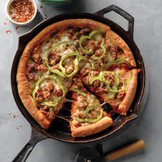 Pizza with green peppers and sausage in a Taste of Home Pre-Seasoned Cast Iron Skillet
