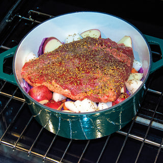 Taste of Home 7-Quart Enameled Cast Iron Dutch Oven with Roast and spices in a pot on a grill