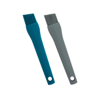 Two Taste of Home pastry and basting brushes, one Sea Green and one Ash Gray, on a white background