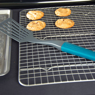 Taste of home slotted spatula on cooling rack with chocolate chip cookies