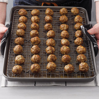 Baking tray with meatballs on a cooling rack