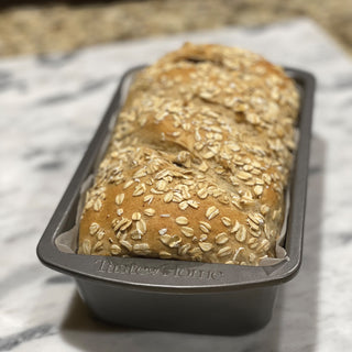taste of home loaf pan angled view on counter with cinnamon raisin break baked in pan