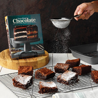 Brownies on a Taste of Home cooling rack with a cookbook titled 'Taste of Home Chocolate' in the background.
